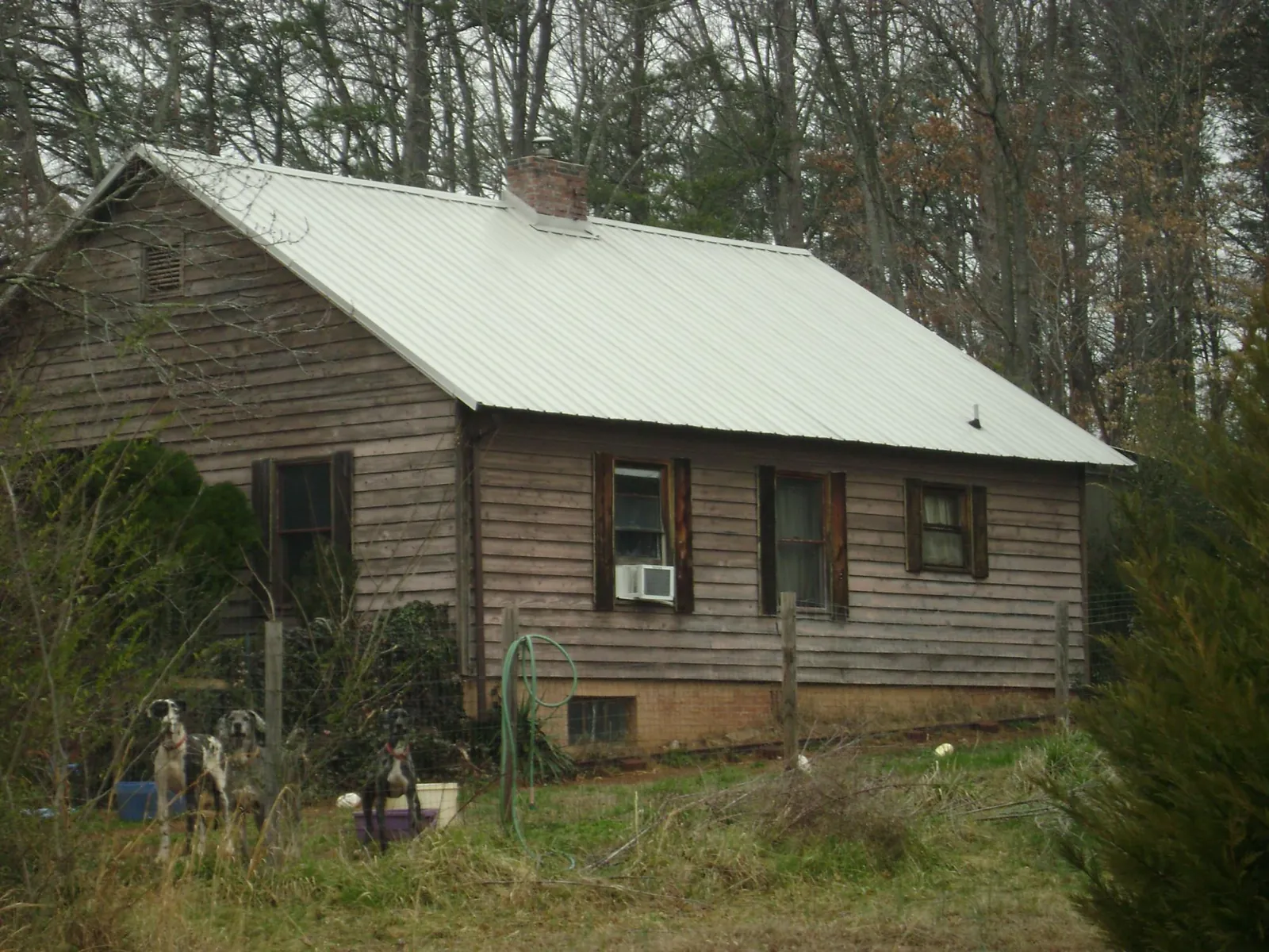 White metal roof on an old wood sided farmhouse, from a Metal Roof Installation job in Hathorne